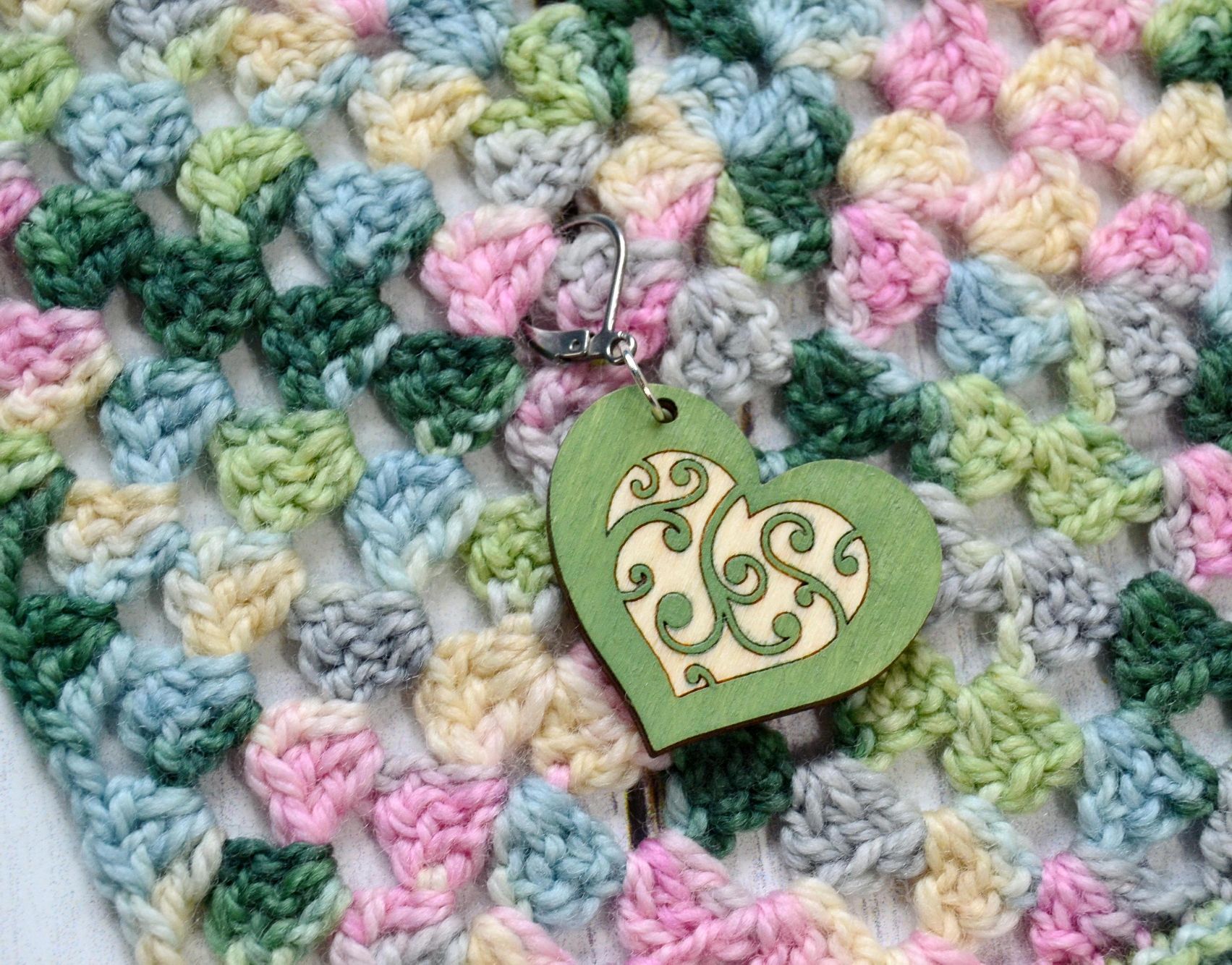 Heart stitch marker on crochet background